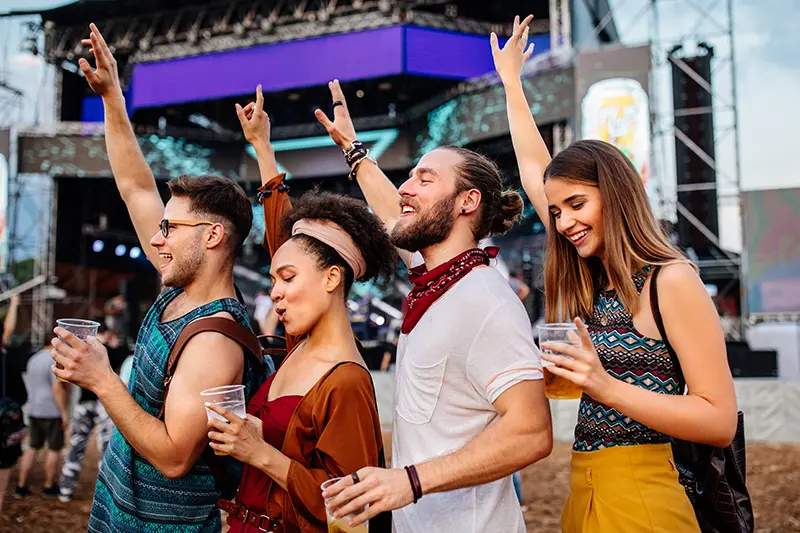 Four friends dancing at a music festival