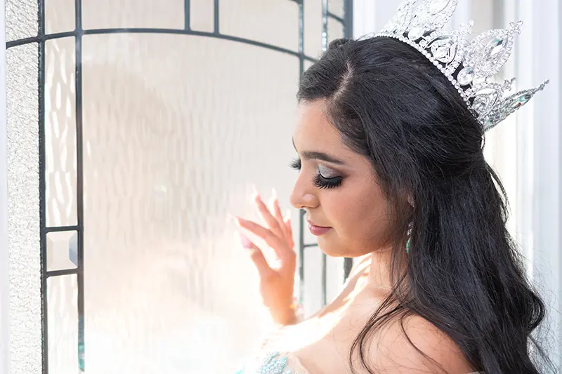 Young teen hispanic girl wearing a quinceanera dress